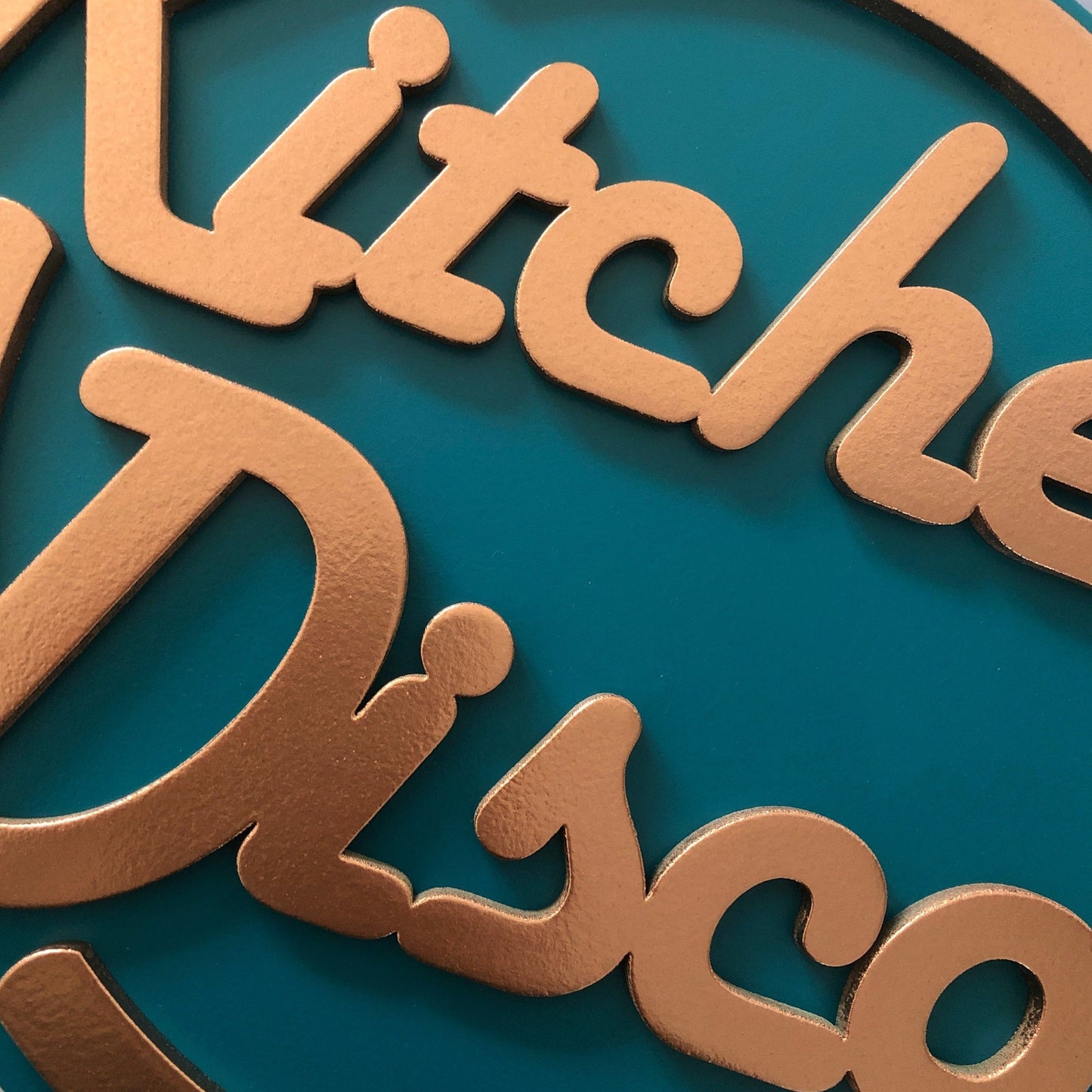 Kitchen Disco sign in teal and copper